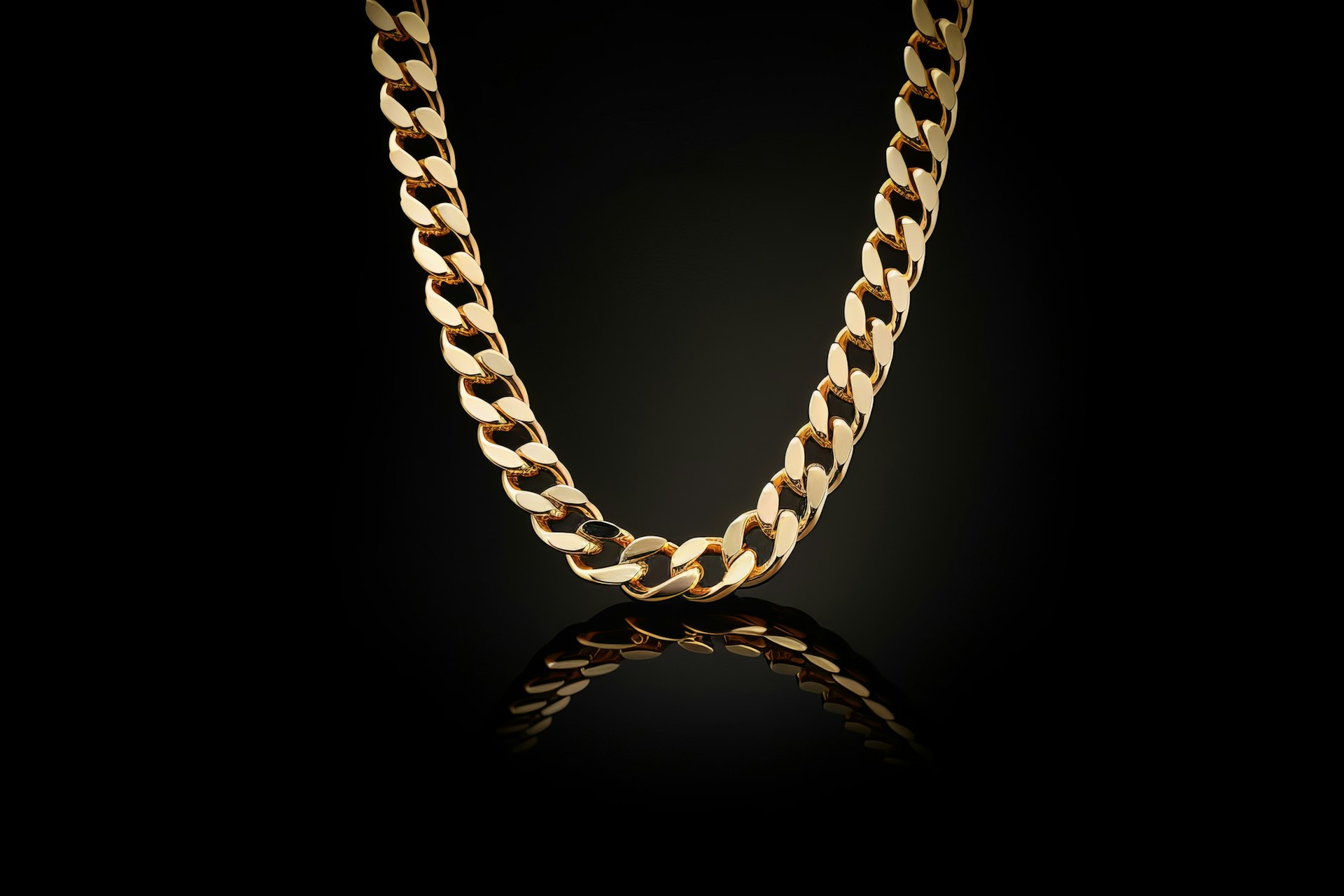 A gold chain on a black bac